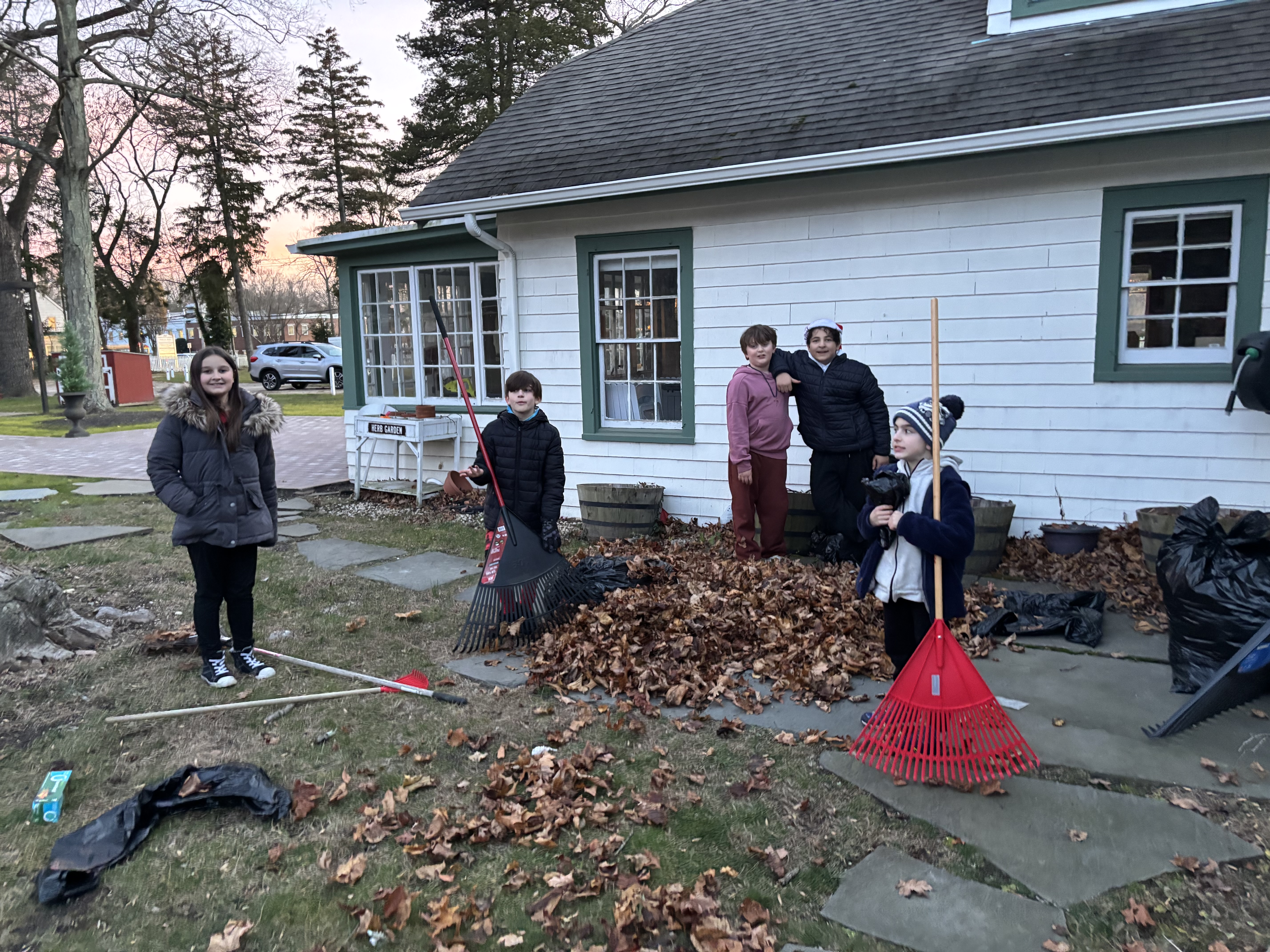 Builders Club members raking leaves for a community service project